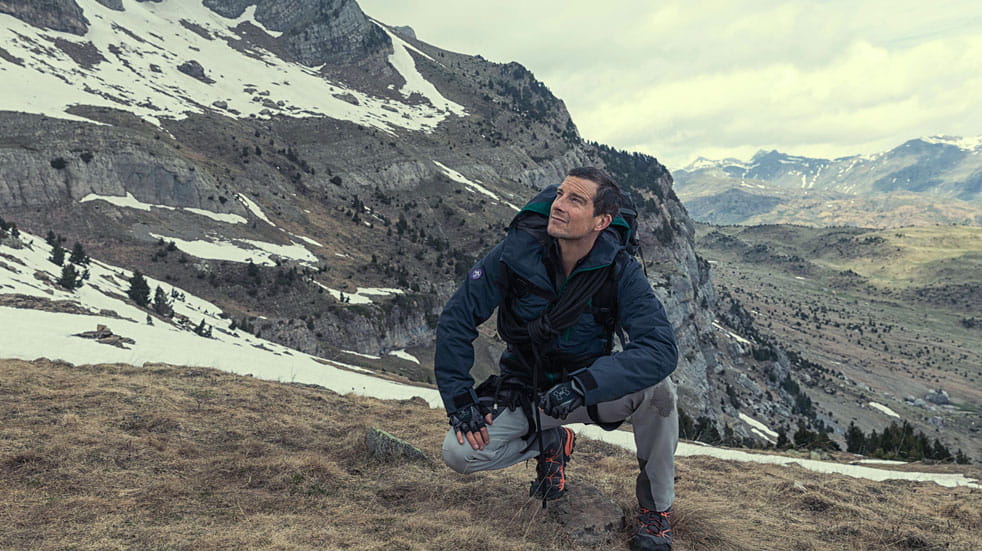 Bear Grylls climbs a mountain